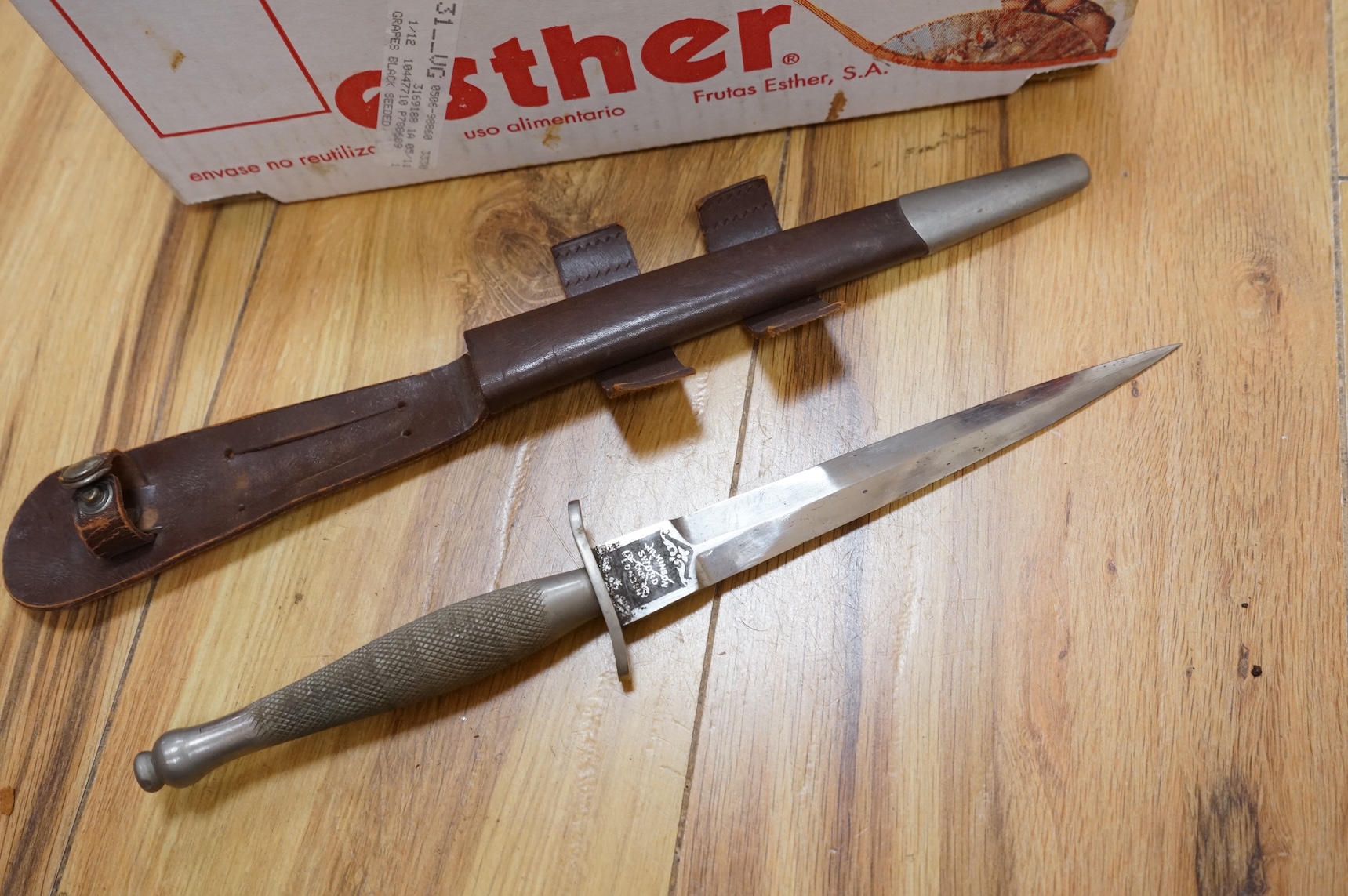 A Sykes-Fairburn Fighting Knife by Wilkinson sword in its leather scabbard, together with a 1942 Mk.III military compass by T.G.Co.Ltd. in a webbing pouch dated 1940, together with another compass, a telescope in a leath